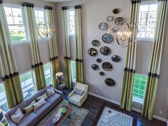 a living room filled with furniture and lots of windows