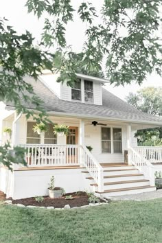 a white house with steps leading up to the front door