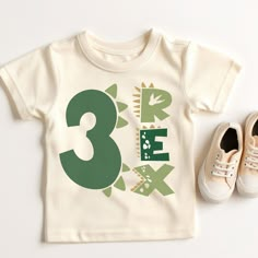 a pair of shoes next to a t - shirt with the number three printed on it