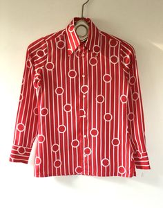 "True vintage top, featuring all over bold red and white geometric pattern, topped with a stately winged collar and classic button up placket. Designer label removed. Approximate Measurements: Shoulder: 14\"; Chest: 35\"; Length: 24.5\"; Labeled a Size 8 Fabric: 100% polyester Eye catching retro blouse, circa 1960s, is in excellent vintage condition. Enjoy! *(International Buyers are welcome - however, please email me so I can check the shipping rate for you before committing to buy.) bt" Patterned Fitted Top For Formal Occasions, Classic Printed Tops For Formal Occasions, Red Graphic Print Button-up Top, Classic Fitted Patterned Tops, Classic Patterned Top For Formal Occasions, Formal Spread Collar Printed Top, Formal Printed Tops With Spread Collar, Formal Printed Top With Spread Collar, Fitted Geometric Patterned Tops