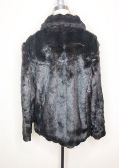 This is a faux fur, reversible jacket by Mackintosh, New England. The fur is soft and cozy and has the look of mink. The buttons look like horn and add a fun vintage flair. The reverse side is brown water resistant fabric, with fur trim. There is some creasing in the reverse fabric (see picture 7) which does not effect wearability. This is a stylish and very practical jacket, ready for whatever Mother Nature has in store. Size tag L. Check measurements carefully. Measurements taken with jacket l Faux Fur Lined Mink Coat, Long Sleeve Faux Fur Mink Coat, Mink-colored Faux Fur Coat, Fall Mink Color Fur Coat With Faux Fur Trim, Mink Outerwear With Faux Fur Trim For Cold Weather, Mink Faux Fur Coat With Faux Fur Lining, Mink Colored Faux Fur Coat, Mink Faux Fur Coat, Brown Water