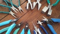 there are many pairs of pliers that are on the table with scissors in them