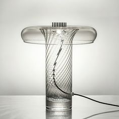 a glass table lamp sitting on top of a white counter