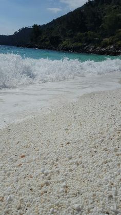 the beach is covered in white sand and water