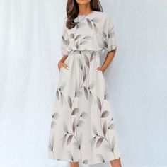 Introducing our "Boho Breeze" short sleeve midi dress - a perfect fusion of style and comfort. This dress boasts a crewneck design, short sleeves, and a flattering fit-and-flare silhouette that exudes bohemian charm. The 4-way stretch fabric, crafted from a blend of 95% polyester and 5% spandex, ensures optimal comfort and flexibility for all-day wear.  The regular fit and elastic waistband provide a tailored look while allowing for easy movement. With convenient pockets, this dress seamlessly c Casual Printed Knee-length Midi Dress, Casual Half Sleeve Maxi Dress For Vacation, Casual Knee-length Printed Midi Dress, Casual Half Sleeve Midi Dress For Vacation, Casual Beach Midi Dress With Half Sleeves, Casual Midi-length Short Sleeve Beach Dress, Casual Midi Length Short Sleeve Beach Dress, Casual Printed Beige Midi Dress, Casual Beige Printed Midi Dress