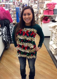 a woman standing in front of a christmas sweater