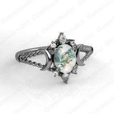 a ring with an image of the earth on it and diamonds in the middle, sitting on