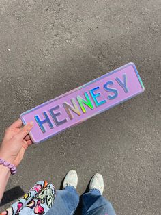 a person holding a sign that says hennesy