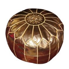 a brown and gold colored poufce sitting on top of a white background