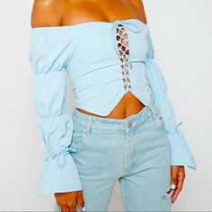 Blue Lace Up Triple Puff Sleeve Top Crop Top Silhouette Puff Sleeve Detailing Long Sleeves Self Tie Lace Up Front Detailing Self Tie Wrist Straps Fabric: 87% Cotton, 13% Elastane Chic Blue Crop Top For Fall, Blue Puff Sleeve Crop Top For Spring, Trendy Blue Puff Sleeve Blouse, Blue Stretch Blouse For Day Out, Blue Fitted Off-shoulder Blouse, Fitted Blue Off-shoulder Blouse, Fitted Off-shoulder Blue Blouse, Blue Stretch Blouse For Spring, Top Crop