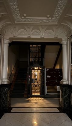 an entrance to a building with columns and doors