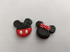 two decorated cookies shaped like mickey and minnie mouse heads