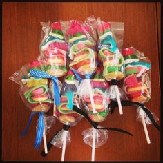 a bunch of lollipops wrapped in plastic on top of a wooden table