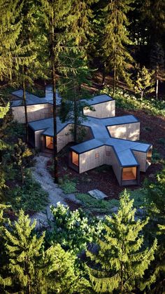 an aerial view of three concrete structures in the woods