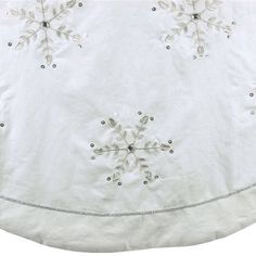 a white tablecloth with snowflakes on it and beaded trim around the edges