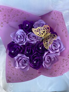 a bouquet of purple roses with butterfly on it