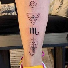 a person with a tattoo on their leg that has the letter m in different languages