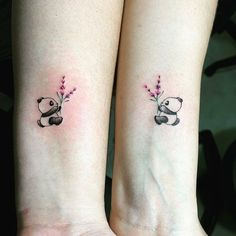 two small tattoos on the arms of people with panda bears holding flowers in their hands