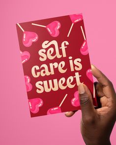 someone holding up a card with the words self care is sweet on it in front of a pink background