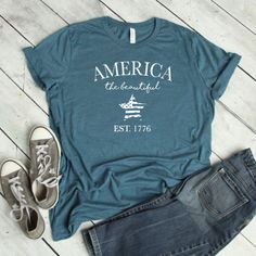 Our shirts are handmade in Ohio by hand with love and care one at a time. We hope you will find a shirt that will inspire you or someone else. This America the beautiful shirt is a must. We use a high-quality unisex t-shirt that is insanely soft. In fact, it will be one of the softest, best fitting, most comfortable shirts you've ever owned. CLICK BELOW https://www.etsy.com/shop/WalnutRidgeCo DETAILS: - This is for 1 graphic shirt. - Available in sizes S-2XL - These are UNISEX fit. - Please refe Pre-shrunk Tri-blend Summer Shirt, Summer Shirt With Text Print For Everyday, Casual Independence Day Shirt With Text Print, Summer Tri-blend Crew Neck Shirt, Relaxed Fit Cotton Shirt For Independence Day, Summer Tri-blend Shirt With Graphic Print, Lake Life Shirt, Braves Shirts, Funny Toddler Shirt