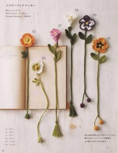 an open book with flowers attached to it