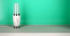 an electric lamp sitting on top of a table next to a green wall and floor