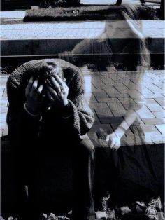 a woman sitting on a bench with her hands covering her face