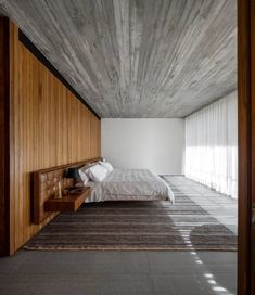 a bedroom with wooden paneling and white walls