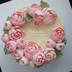 a cake decorated with pink flowers and leaves