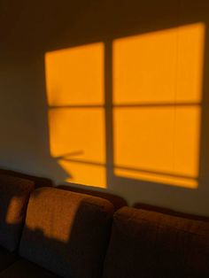 the sun is shining through the window in the living room, casting shadows on the wall