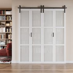 a living room with a book shelf and sliding glass doors