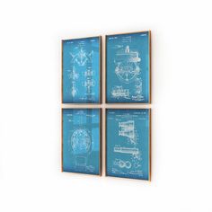 three blueprinted wall hangings on a white wall with a clock in the middle