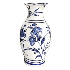 a blue and white vase with flowers on the bottom is sitting in front of a white background