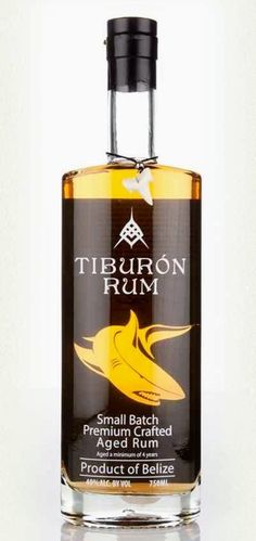 a bottle of tiburon rum sitting on a white surface with the label below it