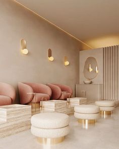 an empty waiting room with pink chairs and stools on the floor in front of a wall