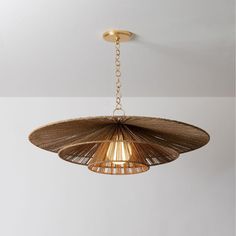 a light fixture hanging from the ceiling in a room with white walls and flooring