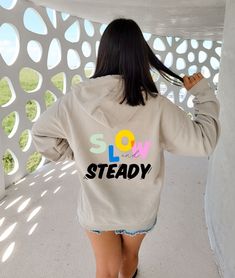 Slow and Steady - Hooodie women's hoodie, trendy sweatshirt, vsco hoodie, cute hoodies, oversized hoody, tumblr, positivity, quote Suggestion:  - Size up 1-2 full sizes for an oversized look A unisex heavy blend hooded sweatshirt is relaxation itself. The material is a thick blend of cotton and polyester. This makes for a plush, soft feel alongside warmth. It's also a great surface for printing. There are no side seams. A spacious kangaroo pocket hangs in front. The hood's drawstring is the same Trendy Oversized Sweatshirt With Drawstring Hood, Vsco Long Sleeve Hoodie With Letter Print, Trendy Tops With Drawstring Hood, Vsco Style Hoodie With Letter Print, Trendy Relaxed Fit Crew Neck Hoodie, Trendy Relaxed Fit Sweatshirt, Trendy Cotton Hoodie, Cotton Vsco Hoodie With Relaxed Fit, Trendy Slogan Hoodie Top