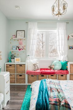 a bedroom with a bed, window and dressers in it's center area