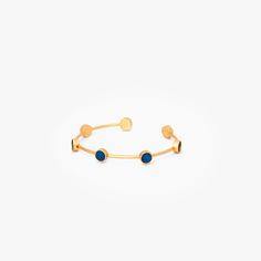 a gold bracelet with two blue stones on the front and one yellow bead at the back