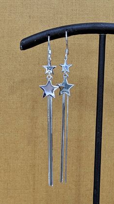 925 Sterling Silver Long Star Dangle Earrings Real 925 Sterling Silver NOT SILVER PLATED High Quality Silver Earrings High polished rhodium finish gives this earrings a stunning shiny look that lasts many years. We have hundreds Silver Jewelry in stock. If you don't see what you are looking , feel free to ask us. Trendy, dainty, luxurious, classic with modern touch, elegant and fancy, fine quality made 925 Sterling Silver long dangle star earrings Description 925 Silver Long Star Earrings Metal Silver Star-shaped Jewelry With Dangling Charms, Adjustable Sterling Silver Earrings With Star Charm, Elegant Silver Earrings With Star Charm, Silver Sterling Silver Earrings With Star Charm, Silver Star Charm Earrings, Sterling Silver Star Charm Drop Earrings, Sterling Silver Earrings With Star Charm, Adjustable Star-shaped Sterling Silver Earrings, Silver Star Charm Earrings For Party