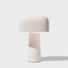 a white lamp sitting on top of a table