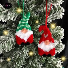 two knitted christmas ornaments hanging from a tree