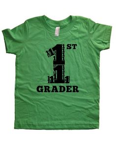 First Grader: Cute School Shirt for Your First GraderThis super soft, pre-shrunk, 100% cotton shirt is designed and printed by us. It is comfortable, durable, and soft. This shirt is gift-friendly, and it arrives wrapped in tissue paper.☆COLORS and SIZES AVAILABLE☆SHIRT COLORS: Purple, Green, Gray, Hot Pink, BlueSIZES: 2T, 4T, 6, 8, 10, 12The INK COLOR is:Black on Green and Gray; Light Blue on Blue; Pink on Hot Pink and PurpleGrades Kindergarten through 5th Grade available: http://www.etsy.com/s Green Letter Print T-shirt For End Of School Year, Green Text Print T-shirt For School, Green School Tops With Text Print, Green Crew Neck Shirt With Name Print, Green Text Print School Tops, Short Sleeve Cotton Shirt With Number Print, Green Text Print Top For School, Green Graphic Print School Shirt, Green Graphic Print Shirt For School