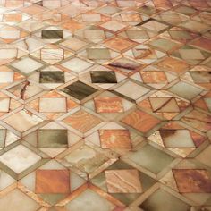 the floor is made up of many different colored tiles