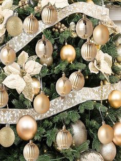 a christmas tree decorated with gold and silver ornaments