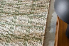 a close up view of a rug on the floor next to a computer mouse and keyboard