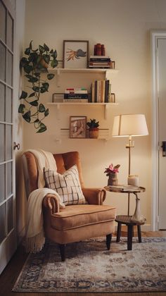 a living room with a chair, lamp and bookshelf