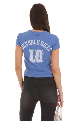 Heart Beverly Hills T-Shirt in Blue | LUCY IN THE SKY Washed Blue Crew Neck Tops With Screen Print, Washed Blue Cotton Tops, Blue Graphic Tee For College, Sporty Blue Tops With Text Print, Blue Cotton Tops With Graphic Print, Washed Blue Cotton Top With Letter Print, Blue Cotton Tops With Letter Print, Blue Cotton Tops With Text Print, Light Blue Cotton Tops With Letter Print