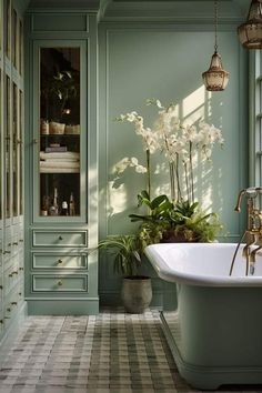 a bath tub sitting next to a window filled with plants and potted plantes