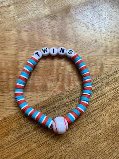 Are you a Minnesota Twins fan?  Wear this cute bracelet to the game or even while watching from afar to display your team spirit and fandom!! *PRODUCT DETAILS* ~Bracelets are made with elastic string & clay/polymer beads.  ~The listing is for one bracelet.   ~These bracelets are final sale. ~Colors may differ slightly from photo depending on lighting. *CARE* ~Seller is not responsible for bracelets breaking - highly recommend being gentle with bracelets and not overstretching. Be gentle when putting on and taking off. Products should not be worn in water or while sleeping.  Avoid placing in direct sunlight. *OTHER STYLES* ~See other listings for other teams. ~See other listings for other sports including basketball, baseball, soccer, and football & even ways to personalize.  ~See other lis Customizable White Sports Bracelets, Basketball Bracelets Diy, Basketball Bracelet Diy, Team-colored Sports Event Bracelets, Cheap Customizable Sports Bracelets, Team-colored Bracelets For Sports, Team Bracelets, Sports Bracelet, Polymer Beads